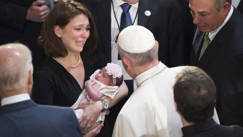 Francis blesses a child at the Capitol.