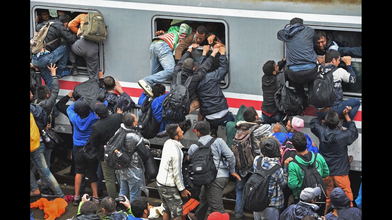 Migrants desperately try to board a train in Tovarnik, Croatia, on Sunday, September 20. Croatia <a href="http://www.cnn.com/2015/09/16/europe/croatia-migrants-refugees/" target="_blank">has opened its borders</a> to refugees and migrants seeking a better life in Europe.
