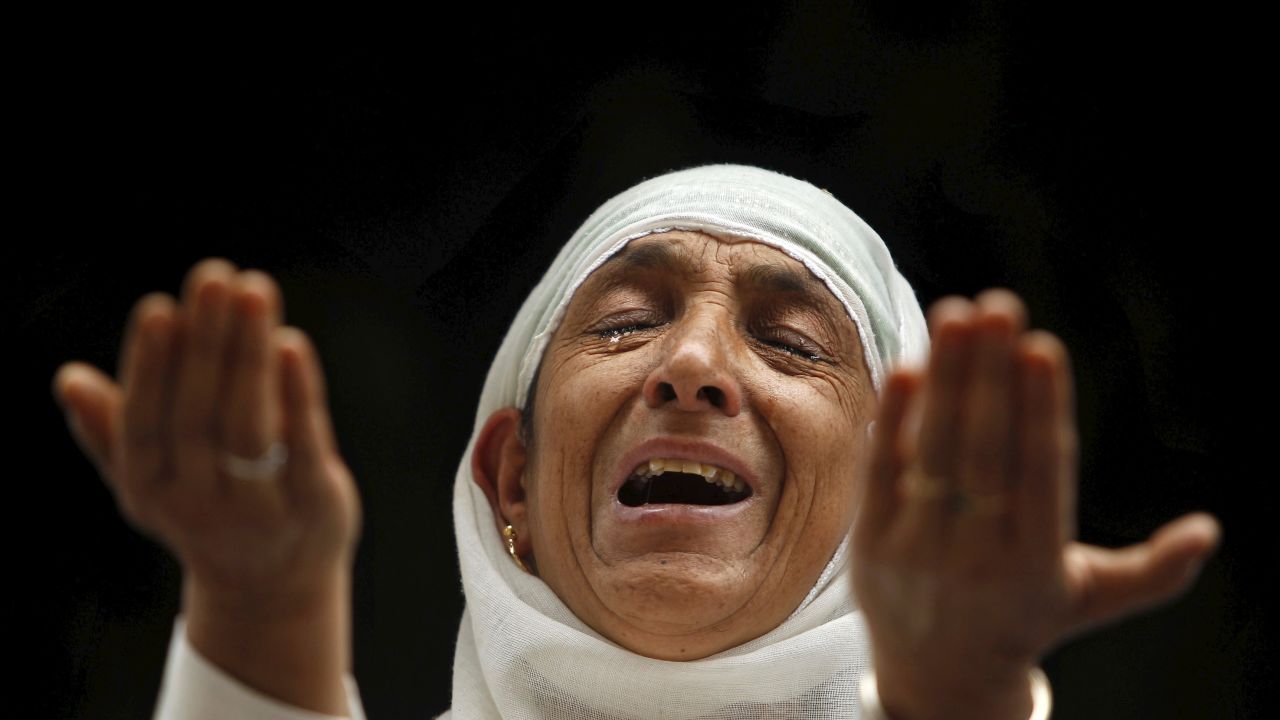 A woman in Srinagar, India, cries as she prays at the shrine of Mir Syed Ali Hamdani, a Sufi saint, during a religious festival marking the anniversary of his death on Monday, September 21.