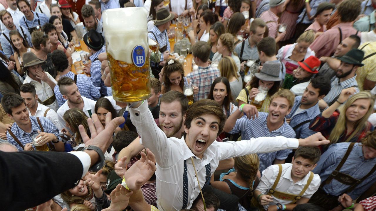 Oktoberfest visitors get their first beers after the festival opened in Munich, Germany, on Saturday, September 19.