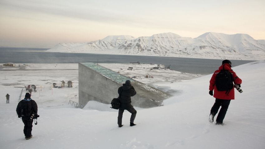 Snow blows off the Svalbard Global Seed Vault as photographers picture it before being inaugurated at sunrise on February 26, 2008 in Longyearbyen. The Global Seed Vault has been built in a mountainside cavern on the island of Svalbard, around 1000 km from the North Pole, to store the world's crop seeds in case of a disaster. AFP PHOTO / DANIEL SANNUM LAUTEN (Photo credit should read DANIEL SANNUM LAUTEN/AFP/Getty Images)