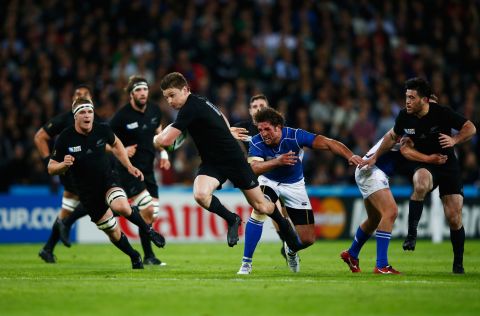 Flyhalf Beauden Barrett breaks past Namibia captain Jacques Burger to score his team's fourth try.