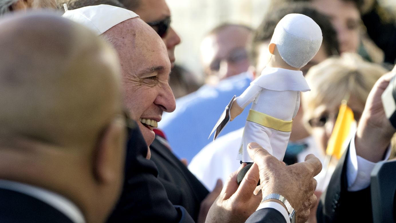 A Pope Francis doll amuses the man himself at John F. Kennedy International Airport.