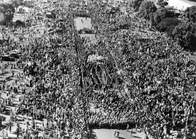 The crowd watches Gandhi's funeral procession.