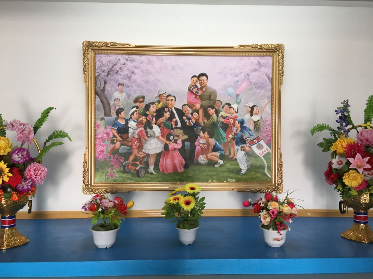 North Korean founder Kim Il Sung, who died in 1994, and his son Kim Jong Il, who died in 2011, are surrounded by beaming children in this popular painting. The supreme leaders visited the Jang Chon cooperative farm on multiple occasions -- the founder himself made 16 trips.