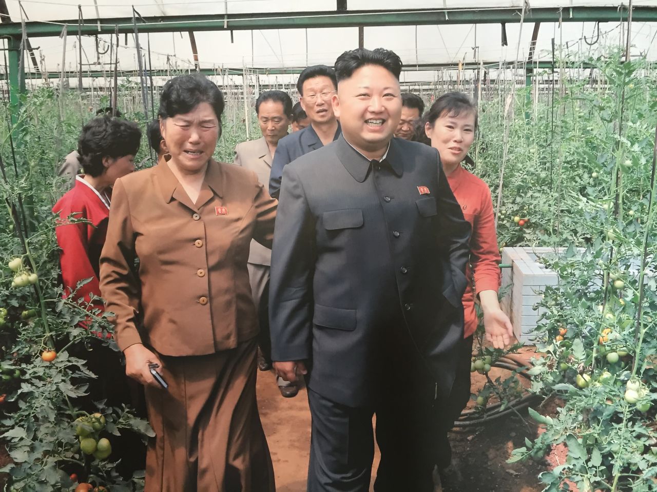 Kim Myong Yon, left, longtime manager of the Jang Chon cooperative farm, sobs as she gives North Korea's current supreme leader Kim Jong Un a tour of the greenhouse. "I was crying very heavily. It was so hot inside (the greenhouse). We felt so sorry for the leader's health," she said.