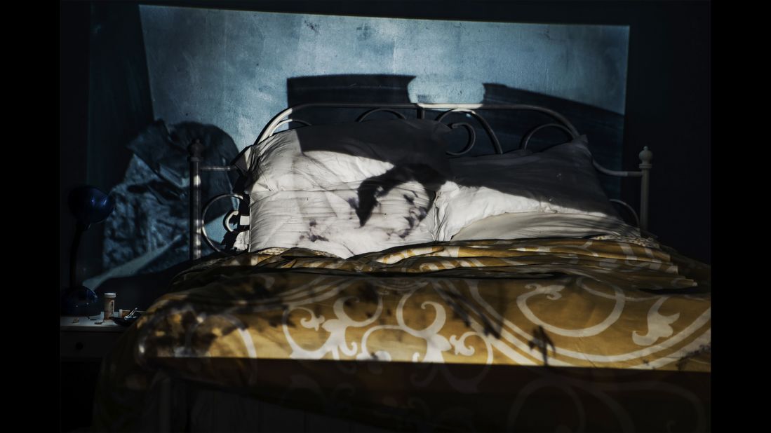 An image of Hannah, sleeping in 1942, is projected onto Cooper's bedroom.