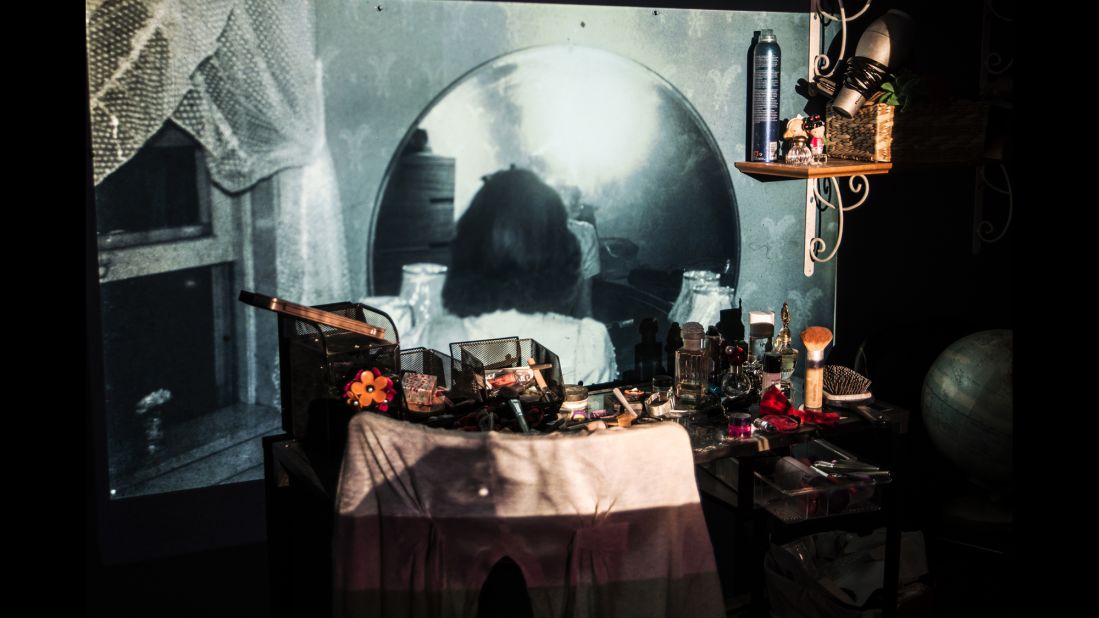 Hannah Cooper sits at her vanity in her 1941 bedroom. The image was projected onto her granddaughter's vanity today.