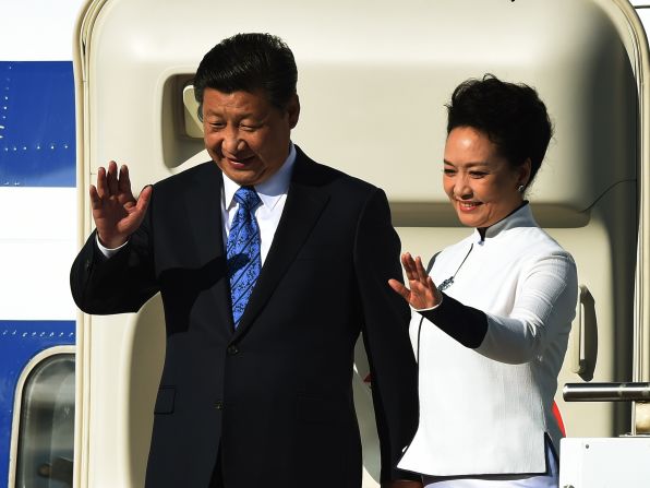 Xi and Peng wave to a crowd in Seattle after arriving in the United States on Wednesday, September 22.