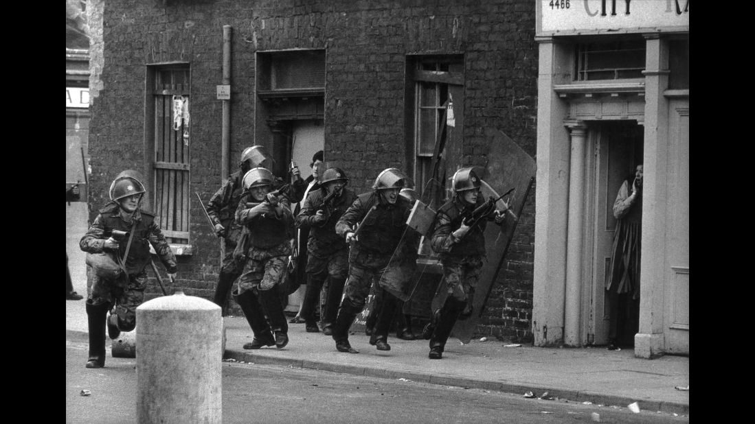 English soldiers charge Catholic youths in Londonderry, Northern Ireland, in 1970.
