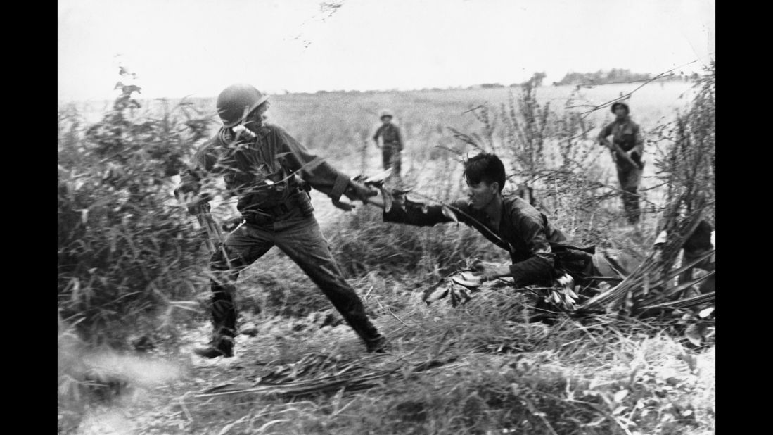 A Vietcong suspect is dragged from his bunker, in South Vietnam in 1965.