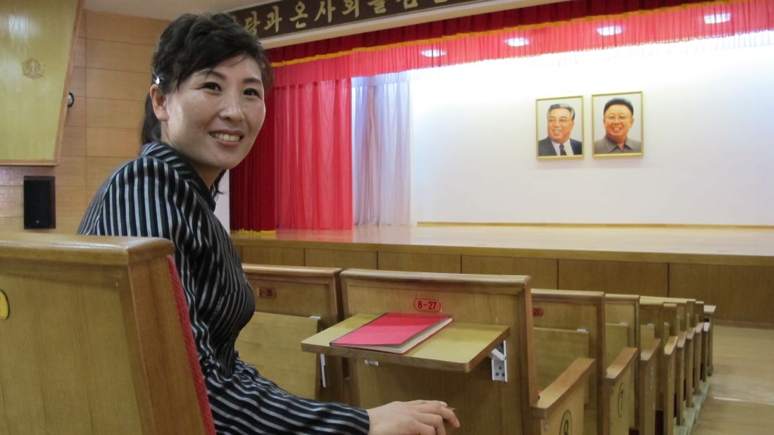 Pak Myong Sim works full-time at the farm -- her job is to show visitors around. She said this auditorium holds events for entertainment and political education. Tables are built-in to the seats to facilitate note-taking. The ubiquitous portraits of Kim Il Sung and Kim Jong Il are of course present,  hung over the center of the stage.