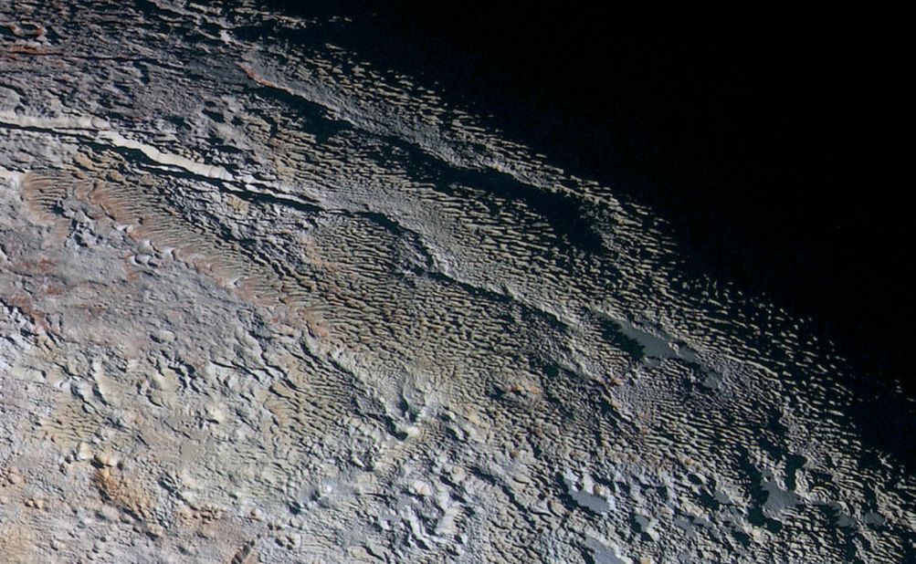 These photos show Pluto's variety of textures, including what NASA calls "rounded and bizarrely textured mountains." The mountains are informally called the Tartarus Dorsa. This image shows about 330 miles (530 kilometers) of Pluto's terrain. It combines blue, red and infrared images taken by the space probe's Ralph/Multispectral Visual Imaging Camera. The images were taken on July 14, during the probe's flyby. They were released on September 24. 