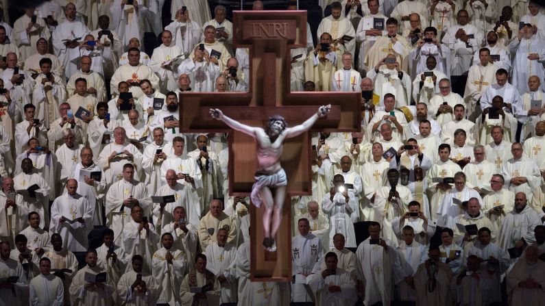 A crucifix hangs above members of the clergy during Mass at Madison Square Garden on September 25.
