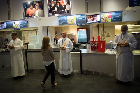 The faithful receive communion at the snack bar during Mass at Madison Square Garden on September 25.