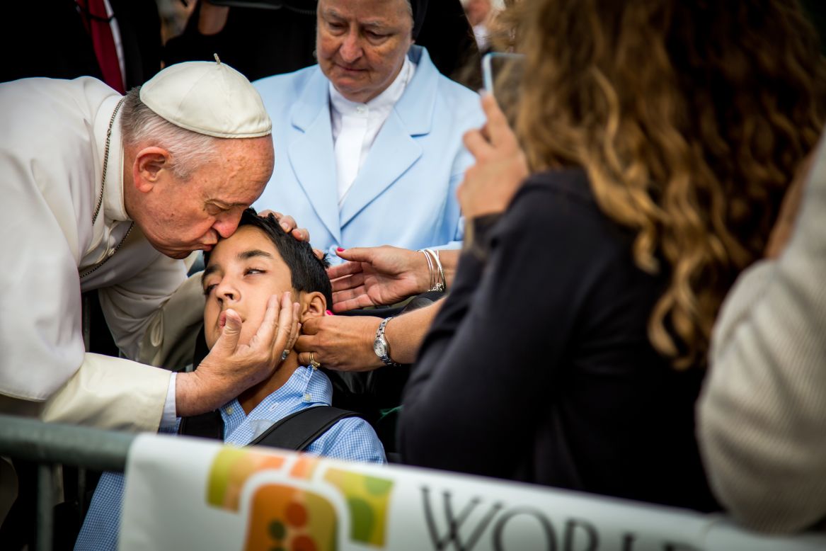 Pope Francis kisses and blesses Michael Keating, 10, of Elverson, Pennsylvania, after arriving in Philadelphia on September 26.  Keating has cerebral palsy and is the son of Chuck Keating, director of the Bishop Shanahan High School band, which performed at Pope Francis' airport arrival. 