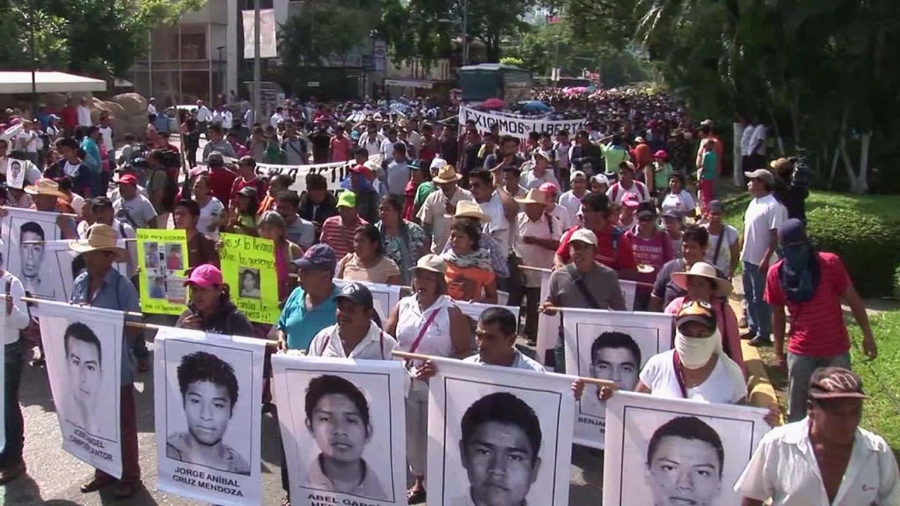 Protesters march near the Angel of Independence monument in Mexico City on Saturday, the first anniversary of the disappearance of 43 college students in Guerrero state.