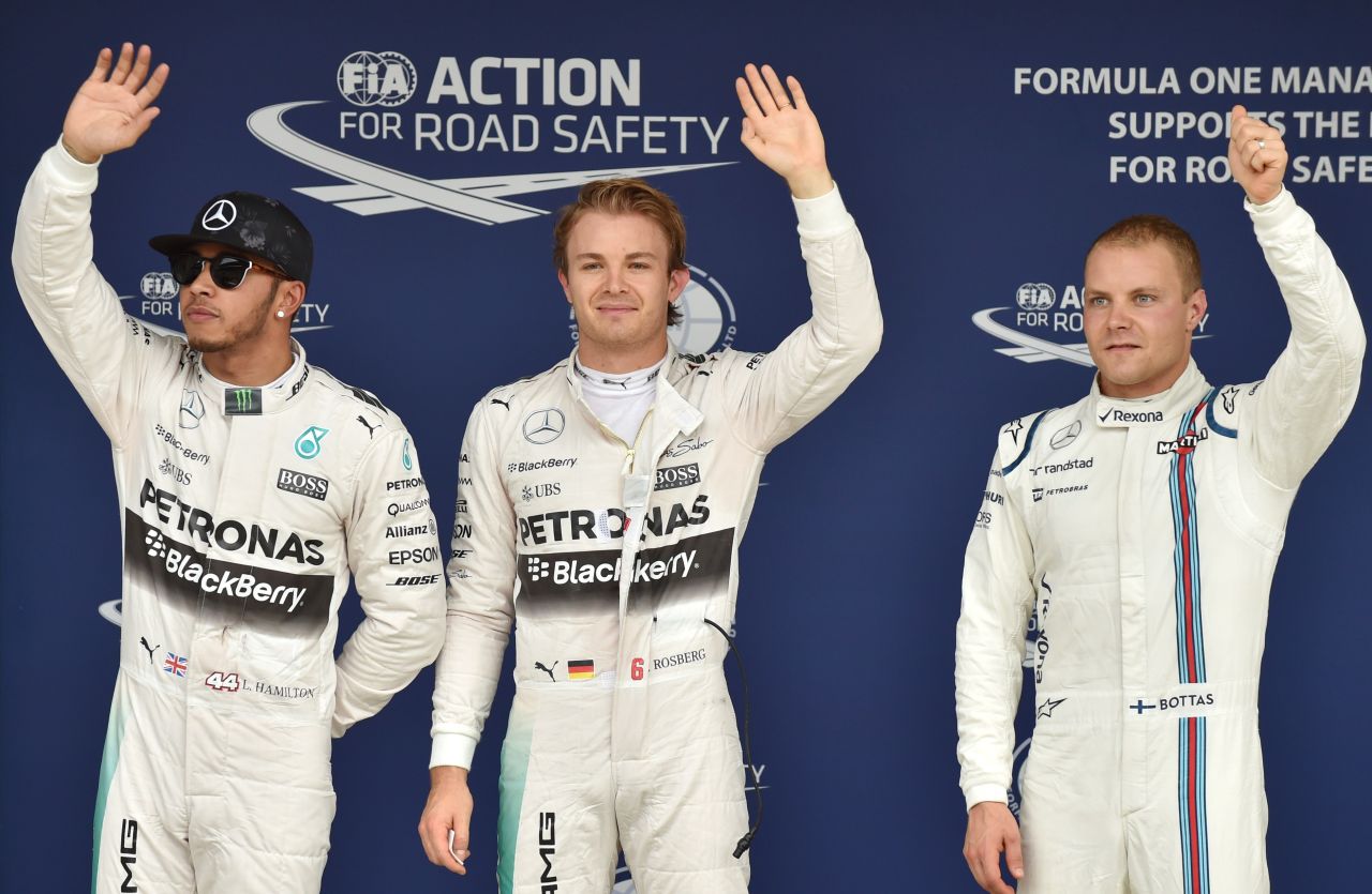 First place Mercedes driver Nico Rosberg of Germany (C), second place Mercedes driver Lewis Hamilton of Britain (L), and third place Williams driver Valtteri Bottas of Finland (R) wave to the crowd after the qualifying session of the Formula One Japanese Grand Prix at the Suzuka circuit.