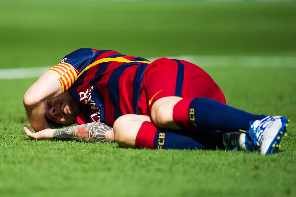 Lionel Messi lays injured on the pitch during the La Liga match between FC Barcelona and Las Palmas at the Nou Camp.