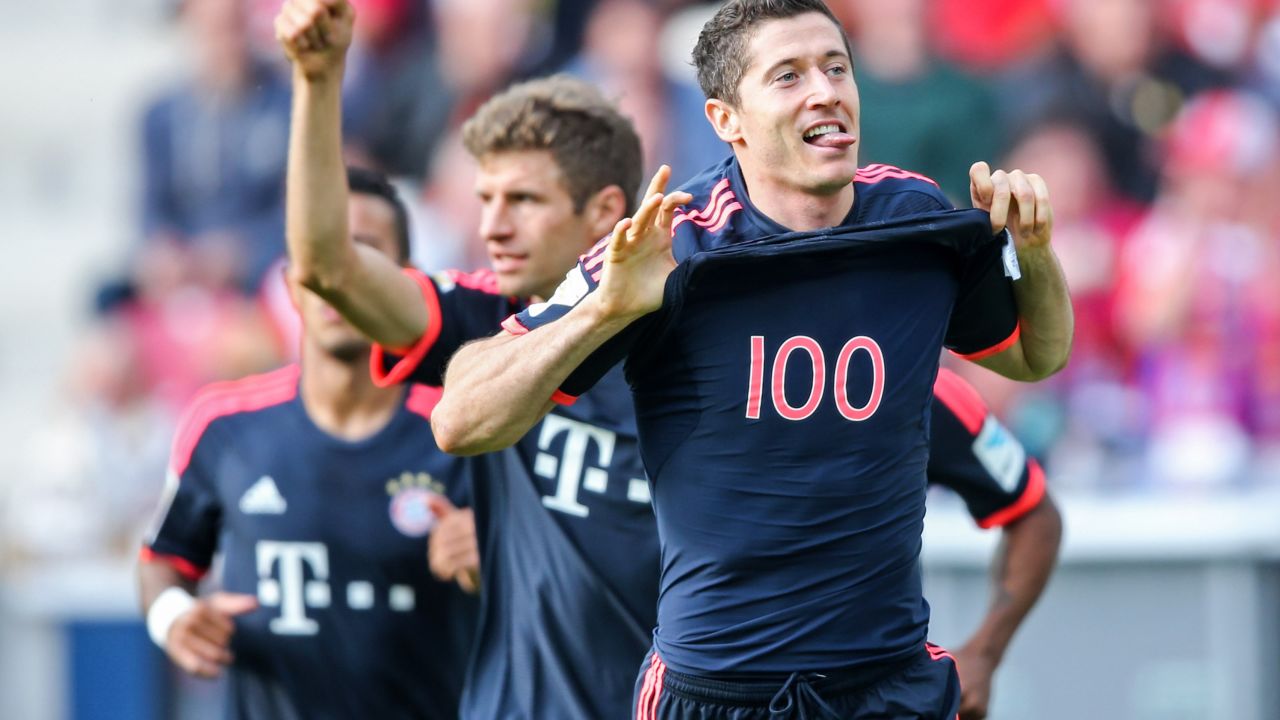  Robert Lewandowski of Muenchen celebrates with team mate Thomas Mueller during the Bundesliga match between Mainz and FC Bayern Munich at the Coface Arena.
