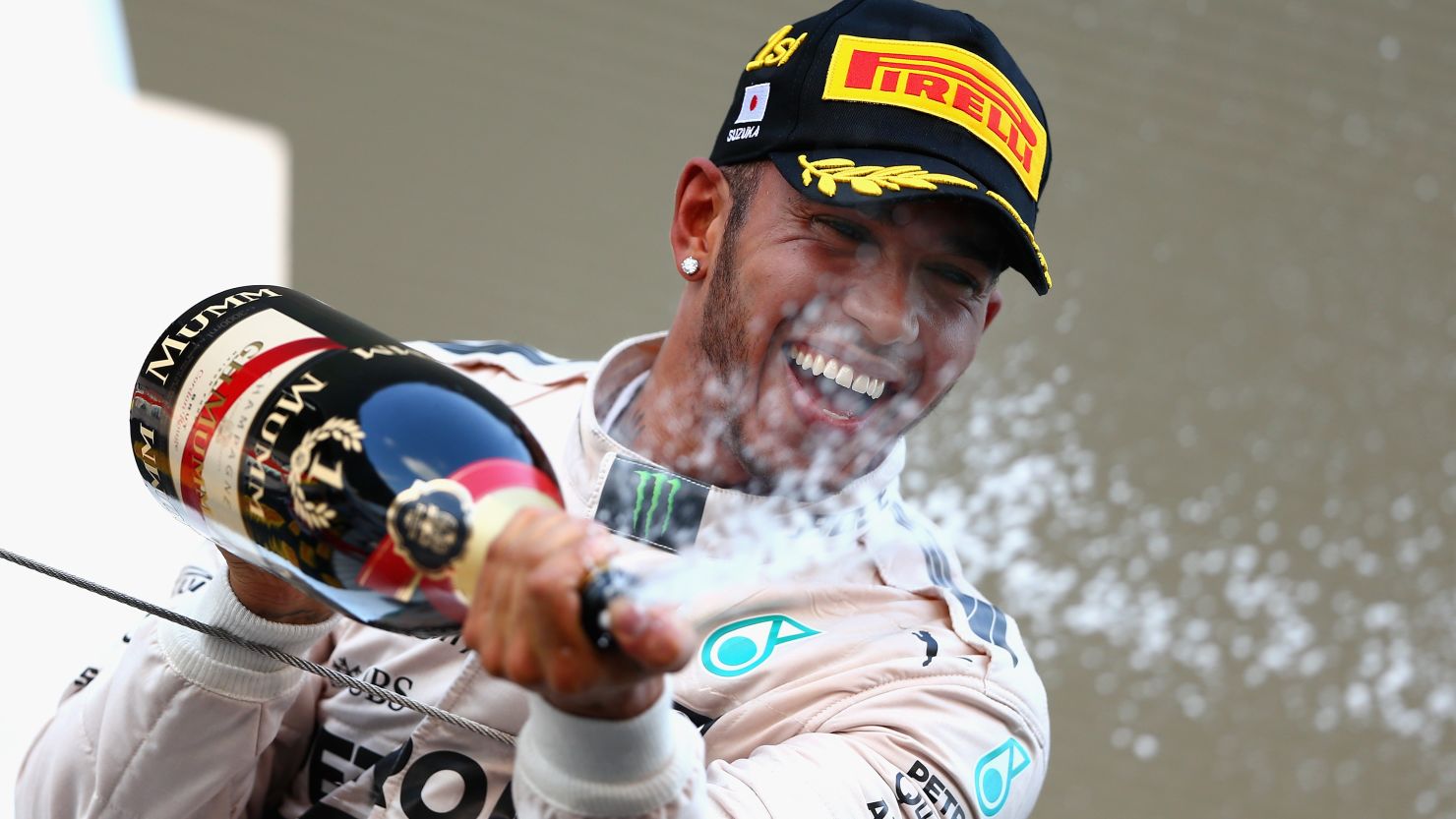 Lewis Hamilton celebrates on the podium after winning the Japanese Grand Prix at Suzuka.