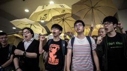 Student protesters Joshua Wong (C), Alex Show (2nd L) and Nathan Law (R) shout slogans outside a court of justice in Hong Kong on September 2, 2015. The students appeared in court for their participation in the 2014 pro-democracy Occupy movement. AFP PHOTO / Philippe Lopez        (Photo credit should read PHILIPPE LOPEZ/AFP/Getty Images)