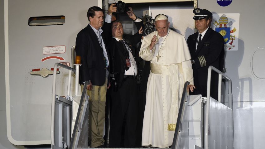 Pope Francis waves from the top of the steps as he prepares to depart Philadelphia International Airport in Philadelphia, Sunday, Sept. 27, 2015, on his way back to Rome. Pope Francis is wrapped up his 10-day trip to Cuba and the United States on Sunday. (AP Photo/Susan Walsh)