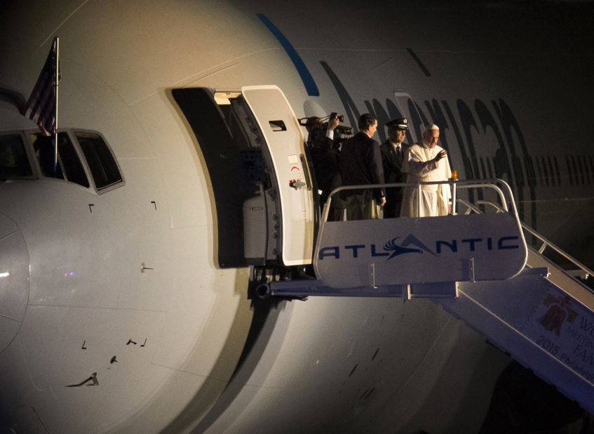 Pope Francis waves from the top of the steps as he prepares to depart Philadelphia International Airport on Sunday, September 27, on his way back to Rome. The Pope has been on a six-day visit to the United States, with stops in Washington, New York and Philadelphia.