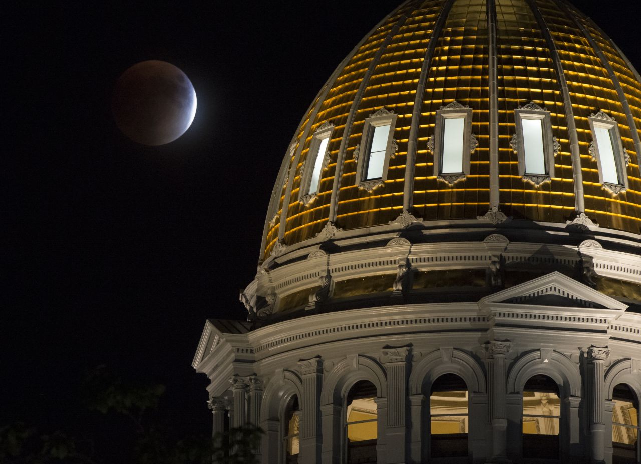 The supermoon is shown during the eclipse next to the Colorado State Capitol building in Denver.
