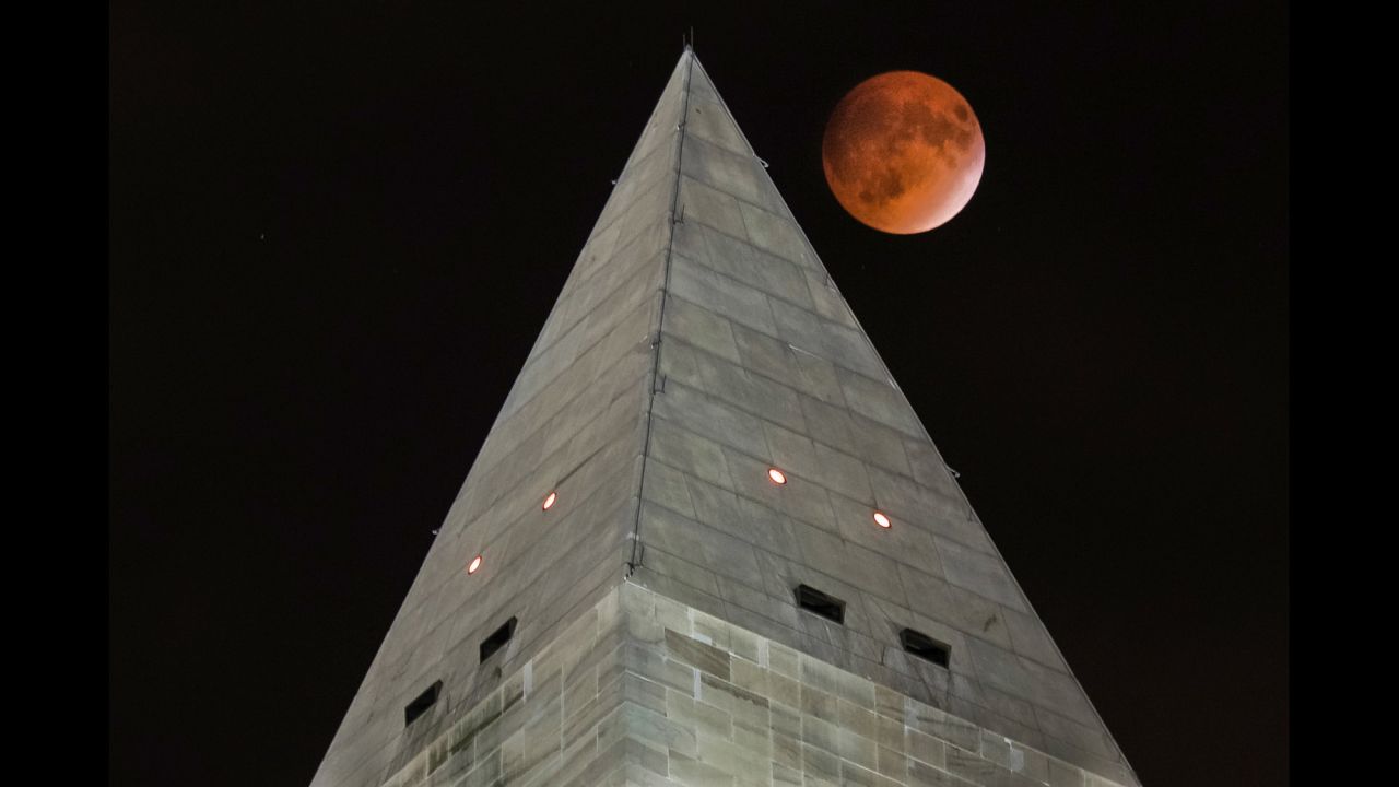 The eclipse is seen next to the Washington Monument.