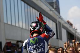 Lorenzo celebrates his victory with a shark fin gesture -- in reference to the helmet design used by Valentino Rossi at Misano.