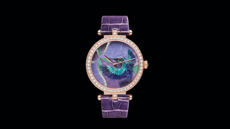 Each individual feather is selected according to its color and texture, and once combined and shaped, placed against scenery within the dial. 