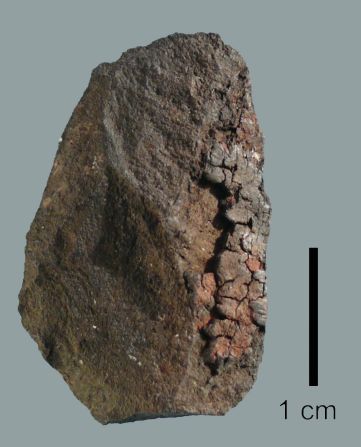 Found in a cave in Sibudu, South Africa, this stone fragment is proof that mankind was creating paint some 49,000 years ago. A <a href="index.php?page=&url=http%3A%2F%2Fjournals.plos.org%2Fplosone%2Farticle%3Fid%3D10.1371%2Fjournal.pone.0131273" target="_blank" target="_blank">scientific study</a> revealed that when tested the residue of the stone contained an mixture of ocher and casein -- a protein found in mammalian milk. The latter acted as a binder for the powdered ocher, with scientists speculating it could have been applied to human skin.