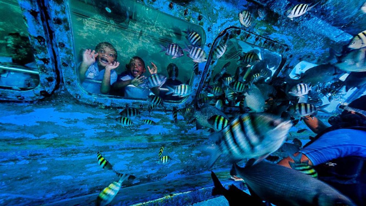 Tourists enjoy Grand Cayman's nearshore coral reefs and crystal clear waters.