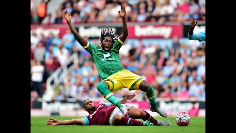 Norwich City striker Dieumerci Mbokani is tackled by West Ham's Winston Reid during a Premier League match in London on Sunday, September 26.