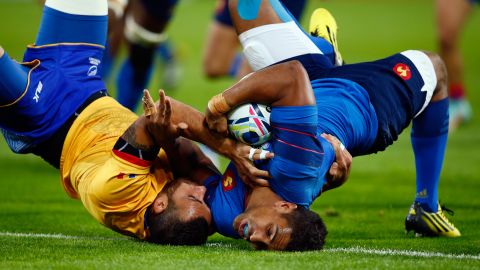 France's Wesley Fofana, right, scores a try as he is tackled by Romania's Madalin Lemnaru during a Rugby World Cup match in London on Wednesday, September 23. France won the match 38-11.