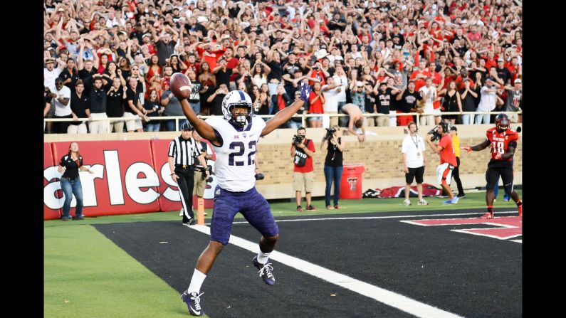 TCU's Aaron Green celebrates his game-winning touchdown in front of dejected Texas Tech fans in Lubbock, Texas, on Saturday, September 26. Green <a href="index.php?page=&url=http%3A%2F%2Fbleacherreport.com%2Farticles%2F2572453-tcu-hanging-onto-playoff-hopes-by-a-thread-after-miracle-win-over-texas-tech" target="_blank" target="_blank">caught the tipped pass</a> on fourth-and-goal from the 4-yard-line, and TCU escaped with a 55-52 victory.