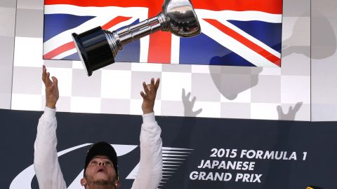 Formula One driver Lewis Hamilton throws his trophy in the air after winning the Japanese Grand Prix on Sunday, September 27. It was his eighth victory of the season.