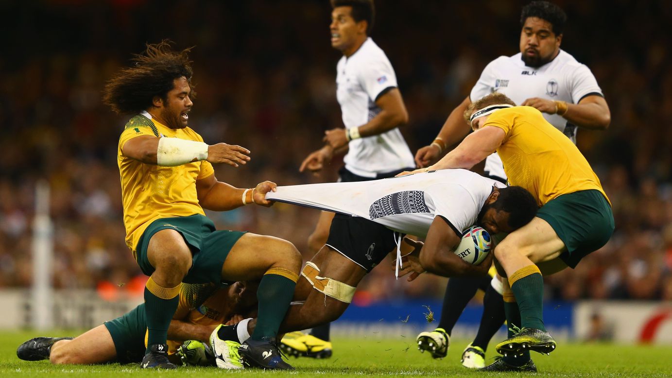 Australian rugby players corral Fiji's Peceli Yato during a Rugby World Cup match Wednesday, September 23, in Cardiff, Wales.