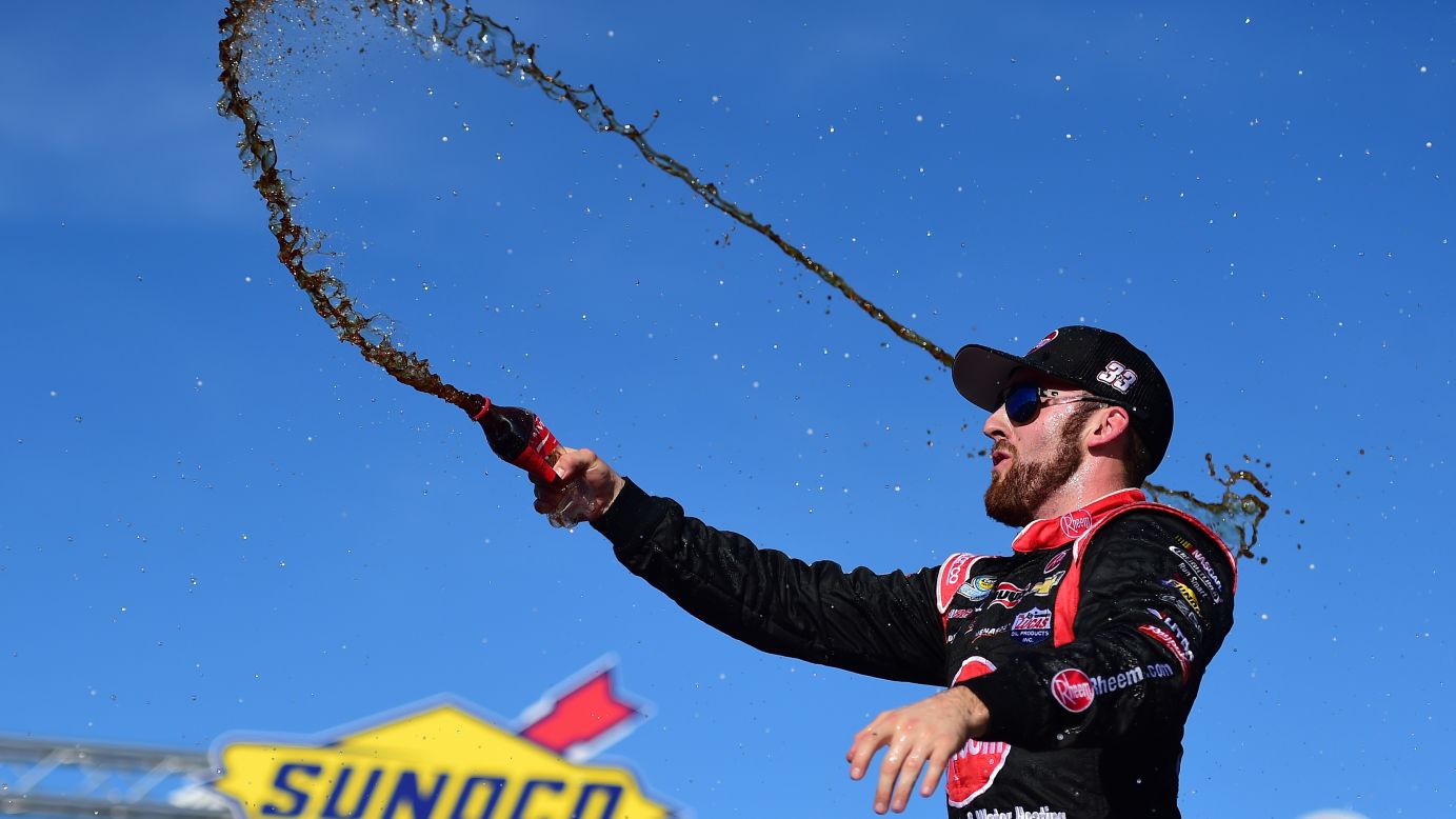Austin Dillon throws a soft drink in the air after winning the NASCAR Truck Series race in Loudon, New Hampshire, on Saturday, September 26.
