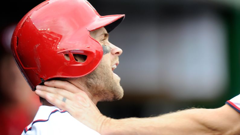 The hand of Washington closer Jonathan Papelbon is wrapped around the throat of teammate Bryce Harper as the two argued in the dugout on Sunday, September 27. Papelbon later apologized, but the team <a href="index.php?page=&url=http%3A%2F%2Fbleacherreport.com%2Farticles%2F2573145-jonathan-papelbon-suspended-by-nationals-latest-details-comments-reaction" target="_blank" target="_blank">suspended him for four games. </a>