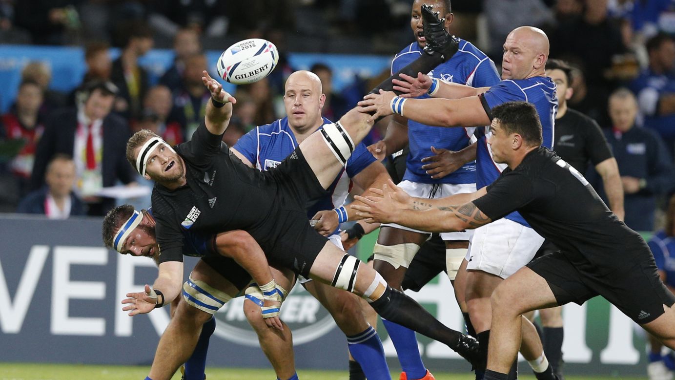 New Zealand's Kieran Read passes the ball to a teammate as he's tackled during a Rugby World Cup match against Namibia on Thursday, September 24.