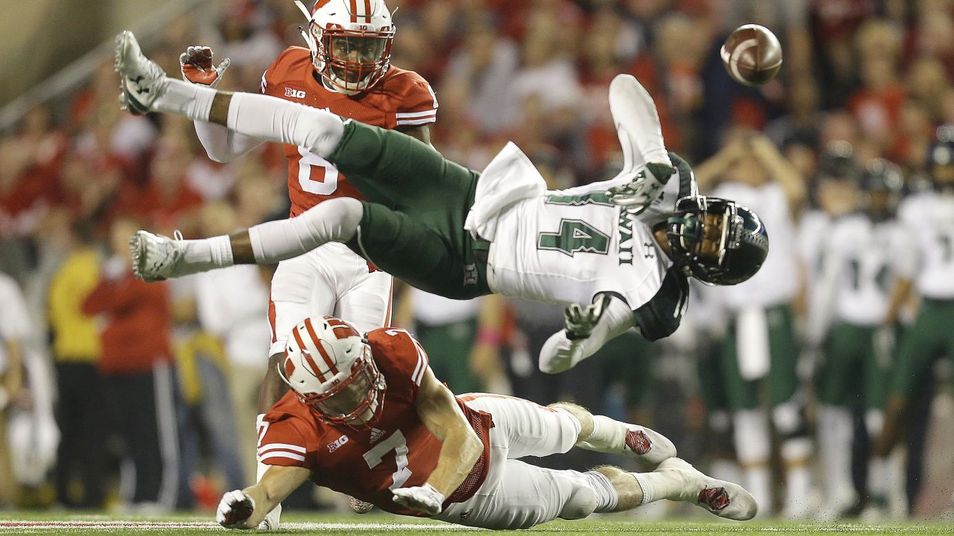Hawaii's Marcus Kemp loses the ball after being hit by Wisconsin's Michael Caputo during a college football game Saturday, September 26, in Madison, Wisconsin.