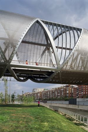 The metallic cone shape encases the structure with a walkway made from wooden slats. 