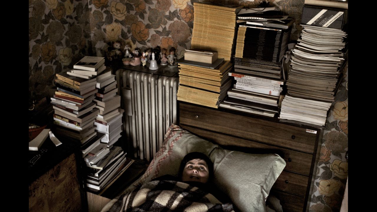 Monia, the sister of photographer Giovanni Cocco, lies in bed in Sulmona, Italy, in 2006. She suffered a traumatic brain injury at birth.