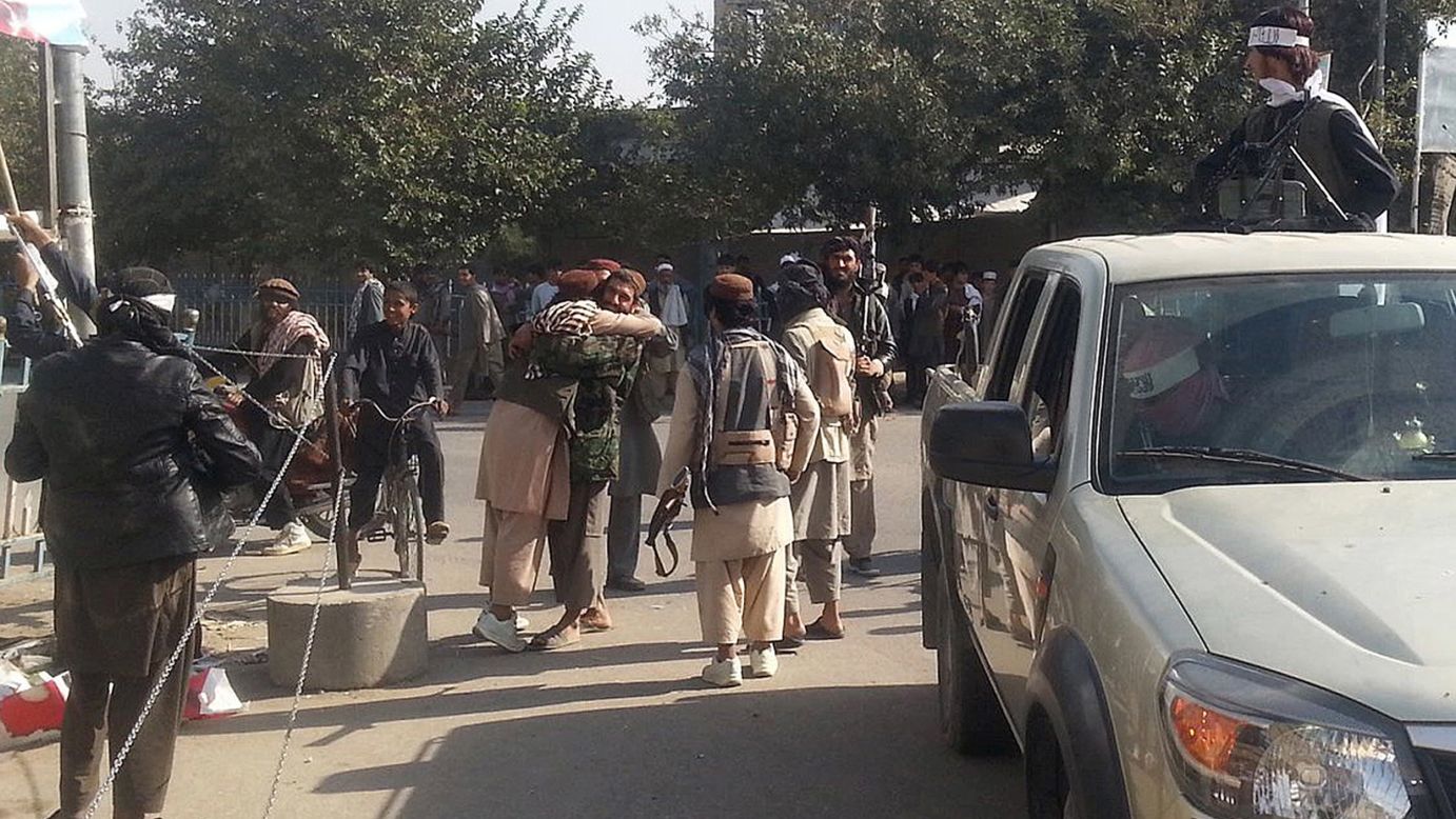 Taliban fighters hug each other on September 29.