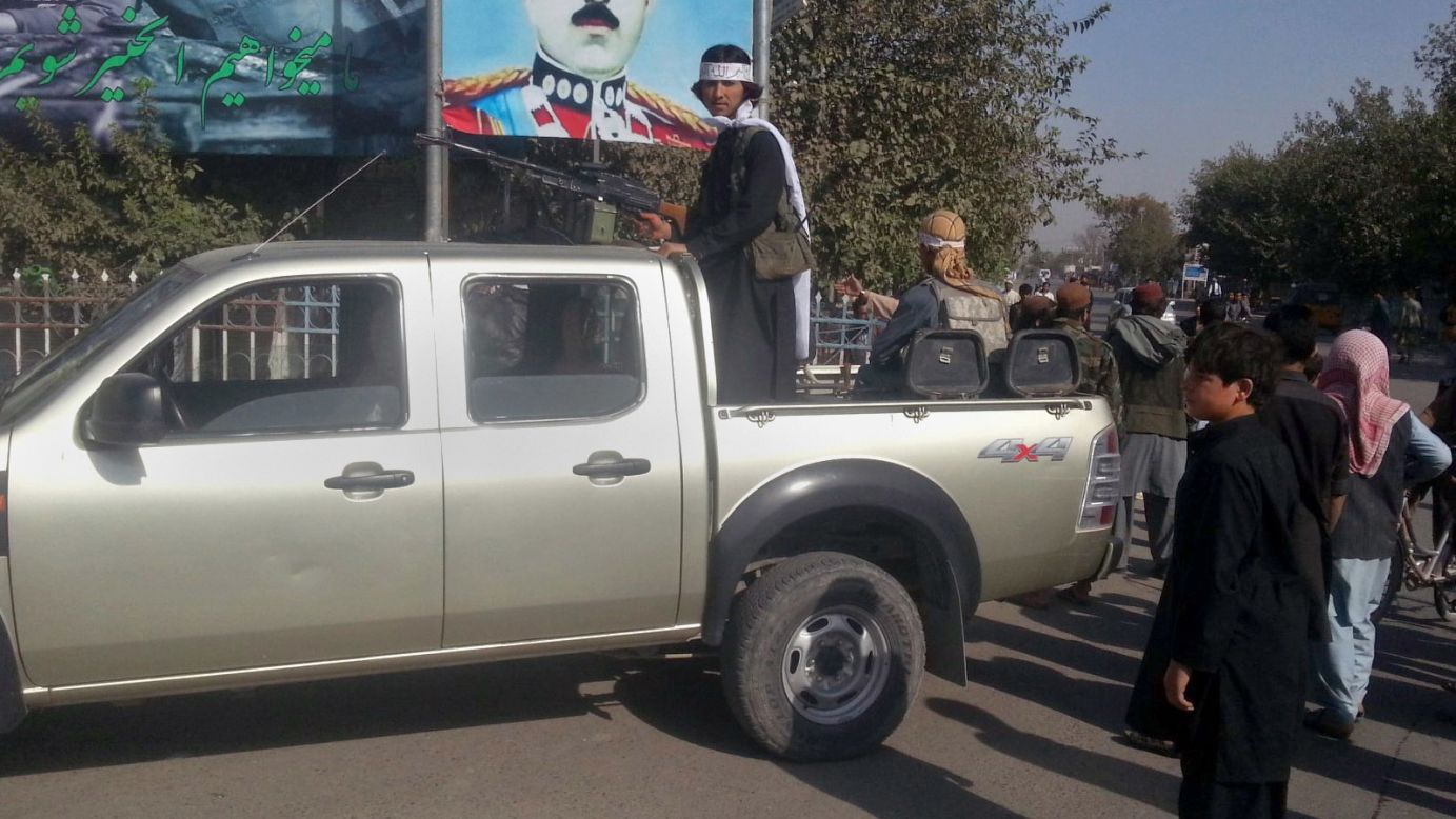 A Taliban fighter stands guard on a vehicle in Kunduz on September 29.