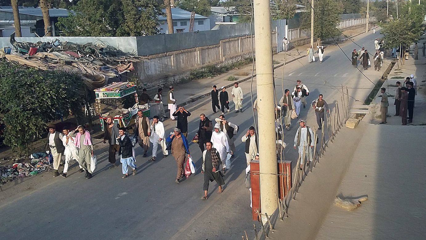 Taliban prisoners walk down a street after they were released by Taliban fighters from the main jail in Kunduz on Monday, September 28.
