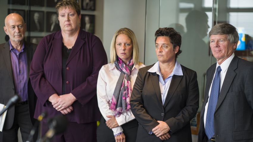 At the law offices of Fafinski Mark & Johnson in Eden Prairie, Minn., former University of Minnesota Duluth women's hockey coach Shannon Miller, second from right, former UMD women's basketball coach Annette Wiles, second from left, former UMD women's softball coach Jen Banford, center, attend a news conference about the discrimination lawsuit they have filed against the school Monday, Sept. 28, 2015. Lawyers Donald Mark Jr., right, and Dan Siegel, left, look on. (Richard Tsong-Taatarii/Star Tribune via AP)  MANDATORY CREDIT; ST. PAUL PIONEER PRESS OUT; MAGAZINES OUT; TWIN CITIES LOCAL TELEVISION OUT