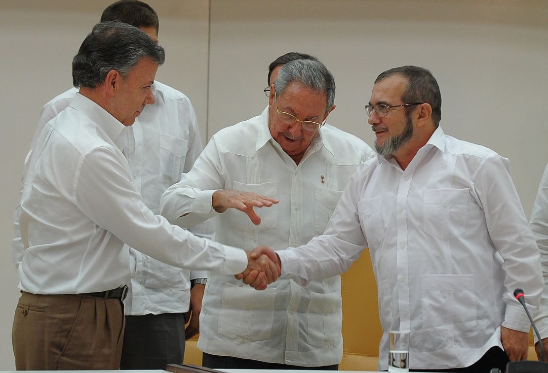 Colombian President Juan Manuel Santos, left, and FARC leader Timoleon Jimenez, right, in Havana.